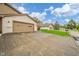 Long concrete driveway leads to an attached garage, set against a brick home with green lawns at 3537 Woodglen Way, Anderson, IN 46011