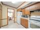Cozy kitchen with wood cabinets, white appliances, and view into the dining area at 3537 Woodglen Way, Anderson, IN 46011