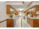 Open-concept kitchen with wood cabinets, a center island, and view of the dining room at 3537 Woodglen Way, Anderson, IN 46011