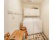 Functional laundry room with washer, dryer, cabinetry, and a laundry-themed storage box at 3537 Woodglen Way, Anderson, IN 46011
