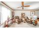 Living room featuring cozy seating, a ceiling fan, and natural light from the window at 3537 Woodglen Way, Anderson, IN 46011