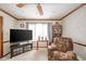 Comfortable living room with carpet, a ceiling fan, a television, and a large window at 3537 Woodglen Way, Anderson, IN 46011
