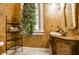 Unique bathroom with decorative walls, a vintage vanity, and a touch of greenery by the window at 4130 N Meridian St, Indianapolis, IN 46208
