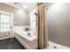 Bright bathroom showcasing a soaking tub, shower with gray subway tile, and modern fixtures at 4130 N Meridian St, Indianapolis, IN 46208