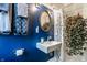 Stylish bathroom with blue walls, white fixtures, and hanging plant for added ambiance at 4130 N Meridian St, Indianapolis, IN 46208