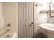 Bright bathroom with white tile, a white vanity, and a white door at 4130 N Meridian St, Indianapolis, IN 46208