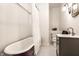 Bright bathroom with black and white tile, clawfoot tub, and vintage-inspired vanity at 4130 N Meridian St, Indianapolis, IN 46208