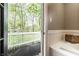 View from a bathroom leading to an outdoor patio area, providing a seamless transition at 4130 N Meridian St, Indianapolis, IN 46208
