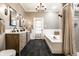 Spacious bathroom with a double vanity, soaking tub, and separate shower with stylish tile at 4130 N Meridian St, Indianapolis, IN 46208