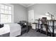 Cozy bedroom featuring a twin bed, work desk, and plenty of natural light from a large window at 4130 N Meridian St, Indianapolis, IN 46208