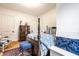 Comfortable bedroom with hardwood floors, four-poster bed, and natural light from window at 4130 N Meridian St, Indianapolis, IN 46208
