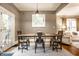 Inviting dining area with rustic wood table, modern lighting fixture, and natural light from the adjacent doorway at 4130 N Meridian St, Indianapolis, IN 46208