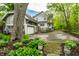 Charming home with attached garage, beautiful landscaping, and a long driveway at 4130 N Meridian St, Indianapolis, IN 46208