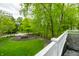 Scenic view from a porch, highlighting lush greenery and a well-maintained front yard with trees at 4130 N Meridian St, Indianapolis, IN 46208