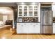 Kitchen featuring white cabinets with glass fronts and a stainless steel refrigerator at 4130 N Meridian St, Indianapolis, IN 46208