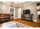 Spacious living room with hardwood floors, piano, and stylish console table, perfect for entertaining at 4130 N Meridian St, Indianapolis, IN 46208