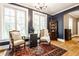 Elegant living room with two chairs, hardwood floors, a rug, and arched doorway, full of natural light at 4130 N Meridian St, Indianapolis, IN 46208