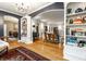 Spacious living room features hardwood floors, a chandelier, and custom built-in bookshelves at 4130 N Meridian St, Indianapolis, IN 46208