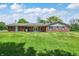 Brick ranch home featuring an attached two-car garage, a large yard, and a paved driveway at 4197 E 250 S, Franklin, IN 46131