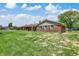 Exterior view of a brick home, showcasing the large backyard, patio area, and well-maintained lawn at 4197 E 250 S, Franklin, IN 46131