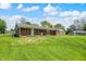 Expansive backyard with brick ranch-style home, featuring a patio area and lush green lawn at 4197 E 250 S, Franklin, IN 46131