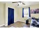 Comfortable bedroom with wood-look floors, a fan, and a closet behind blue curtain at 4197 E 250 S, Franklin, IN 46131