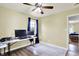 Bedroom features neutral walls, modern ceiling fan and home office setup, with view into adjacent bedroom at 4197 E 250 S, Franklin, IN 46131