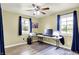 Bright bedroom featuring modern ceiling fan, wood-look floors, and well-lit home office setup at 4197 E 250 S, Franklin, IN 46131