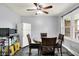 Bright dining area with a round table, ceiling fan, and natural light from the large window at 4197 E 250 S, Franklin, IN 46131