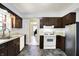 Kitchen featuring white appliances, wooden cabinets, and a double basin sink at 4197 E 250 S, Franklin, IN 46131
