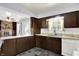 View of the kitchen featuring brown wooden cabinetry, double basin sink, and open layout at 4197 E 250 S, Franklin, IN 46131