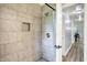 An open shower with ceramic tile, stone floor, and a built-in shower caddy at 4197 E 250 S, Franklin, IN 46131