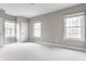 Bright and spacious bedroom with three windows and neutral carpeting at 4332 Heyward Pl, Indianapolis, IN 46250