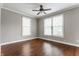 Cozy bedroom with two windows, hardwood floors, ceiling fan and neutral walls at 4332 Heyward Pl, Indianapolis, IN 46250