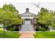 View of the community clubhouse featuring beautiful architecture, a manicured lawn, and mature trees at 4332 Heyward Pl, Indianapolis, IN 46250