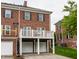 Charming brick townhome with a white balcony, a two-car garage and beautiful curb appeal at 4332 Heyward Pl, Indianapolis, IN 46250
