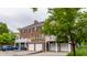 A multi-story brick townhome with an attached garage, featuring an elevated balcony at 4332 Heyward Pl, Indianapolis, IN 46250