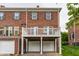 Multi-level townhome featuring a private balcony above two garage doors at 4332 Heyward Pl, Indianapolis, IN 46250