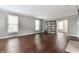 Bright living room with hardwood floors, neutral walls and modern shelving provides a comfortable living space at 4332 Heyward Pl, Indianapolis, IN 46250