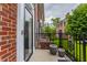 A glass door leads onto the outdoor patio of this red brick townhome at 4332 Heyward Pl, Indianapolis, IN 46250