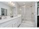 This bathroom offers a spacious glass enclosed shower, a double vanity sink, and tile walls at 5020 Eldon Dr, Noblesville, IN 46062