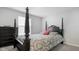 Cozy bedroom features a four poster bed frame with decorative pillows and nearby dresser at 5020 Eldon Dr, Noblesville, IN 46062