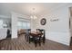 Dining area featuring hardwood floors, a modern light fixture, and decorative wall accents at 5020 Eldon Dr, Noblesville, IN 46062