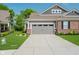 Charming home with grey and brick exterior, well-maintained lawn, and attached two car garage at 5020 Eldon Dr, Noblesville, IN 46062