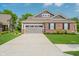 Charming home exterior featuring a gray garage door, brick accents, and a meticulously maintained front lawn at 5020 Eldon Dr, Noblesville, IN 46062
