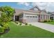 Beautiful two-story home features a brick and gray exterior, well-manicured lawn, and attached two-car garage at 5020 Eldon Dr, Noblesville, IN 46062