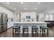 Bright kitchen boasts white cabinets, stainless steel appliances and an island with breakfast bar at 5020 Eldon Dr, Noblesville, IN 46062