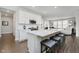 Bright kitchen features an island with a breakfast bar, white cabinets and stainless steel appliances at 5020 Eldon Dr, Noblesville, IN 46062
