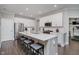 Bright kitchen features white cabinets, stainless steel appliances and an island with counter seating at 5020 Eldon Dr, Noblesville, IN 46062
