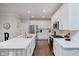 Bright, modern kitchen with stainless steel appliances, white cabinets, and a large center island with counter seating at 5020 Eldon Dr, Noblesville, IN 46062